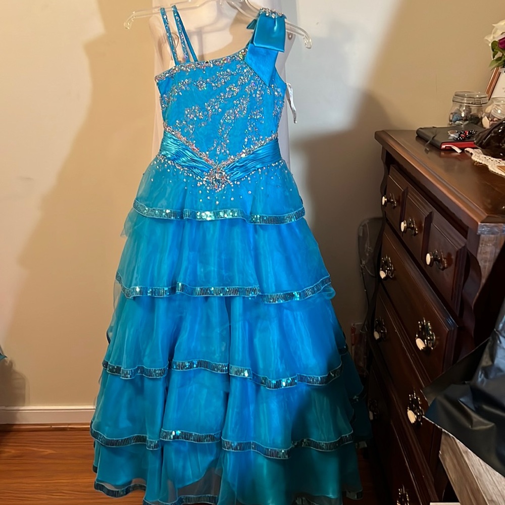 Blue tiered ball gown with stoned bodice.